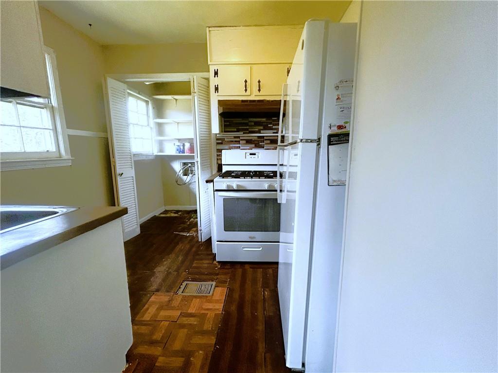 2115 Venesa Circle Austell, GA 30168 - Photo 10 of 28 a view of a kitchen with a sink a refrigerator and a stove top oven