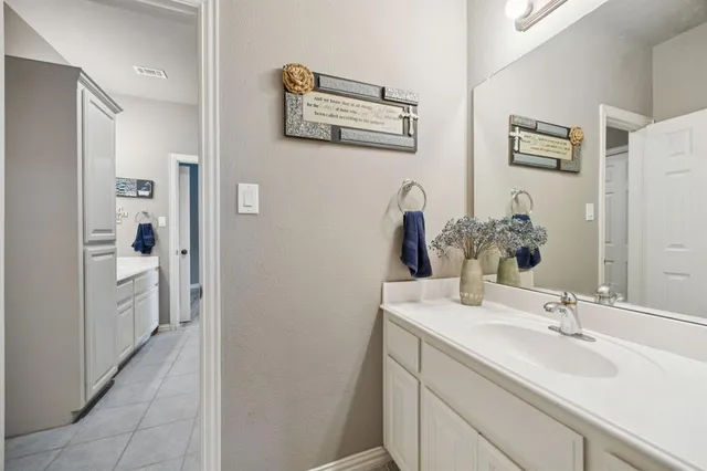a view of a patio with table and chairs and potted plants