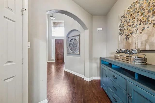 a bedroom with a bed and a flat tv screen on dresser