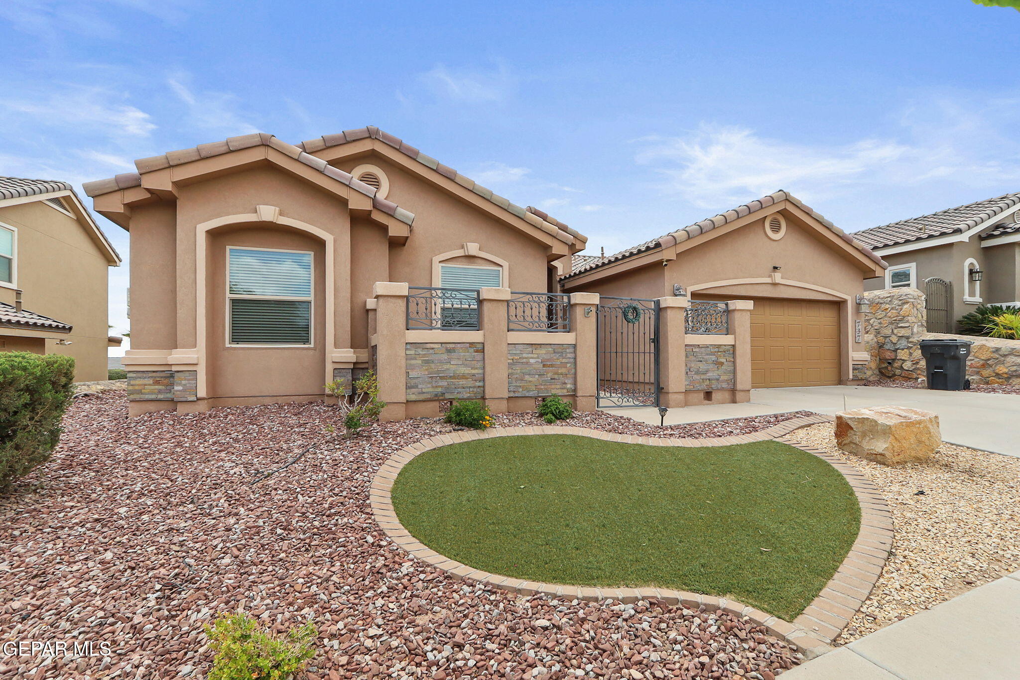 a front view of a house with a garden