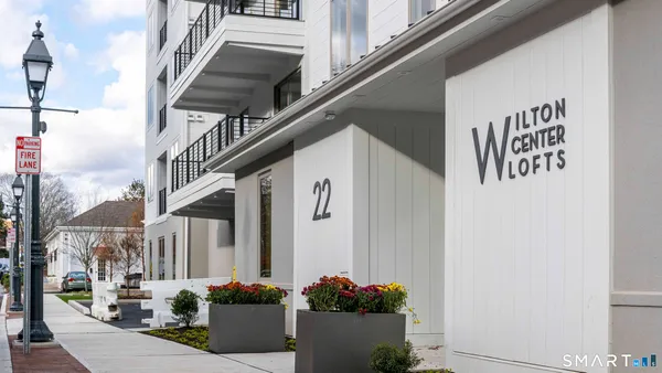 a front view of a house with plants