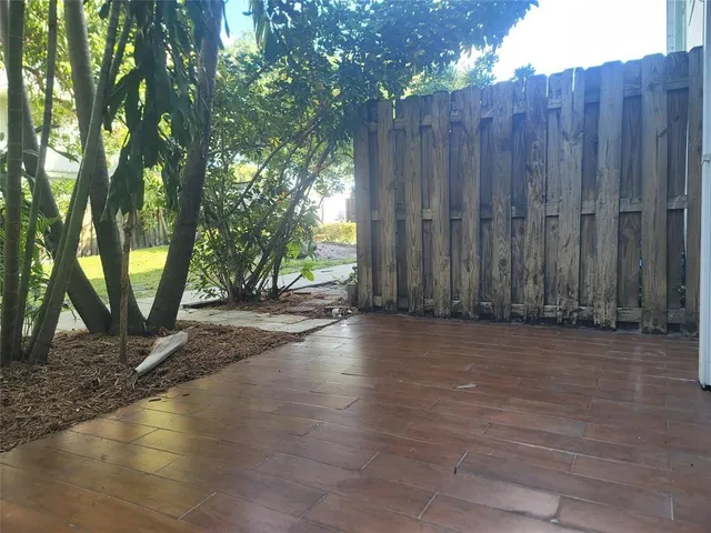 a view of a yard with wooden fence