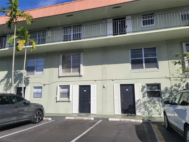 a couple of cars parked in front of a building
