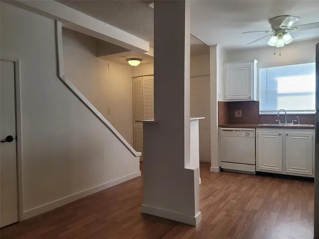 a view of a kitchen with a sink cabinets and wooden floor