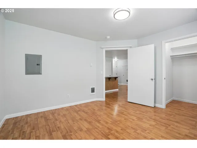 a view of an empty room and wooden floor