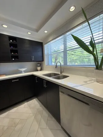 a kitchen with a sink and large window
