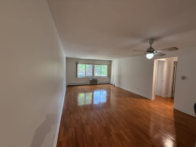 677 South River Road, Unit 2A Des Plaines, IL 60016 - Photo 6 of 15 wooden floor in an empty room with a window