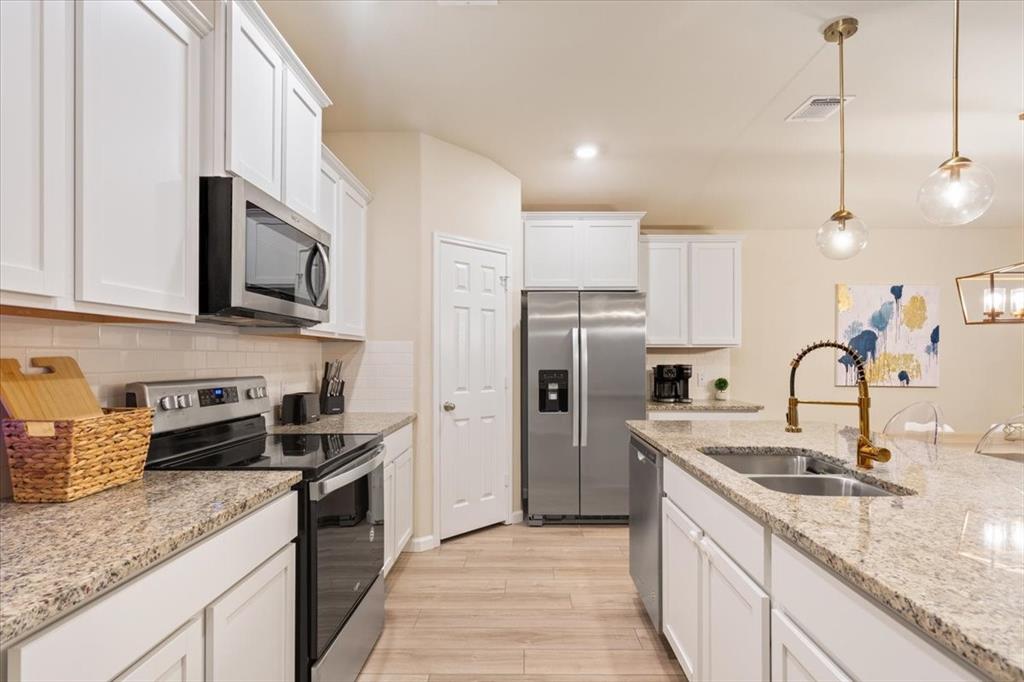 3105 Beutel Road Lorena, TX 76655 - Photo 12 of 26 a kitchen with stainless steel appliances granite countertop a sink a stove a refrigerator and cabinets