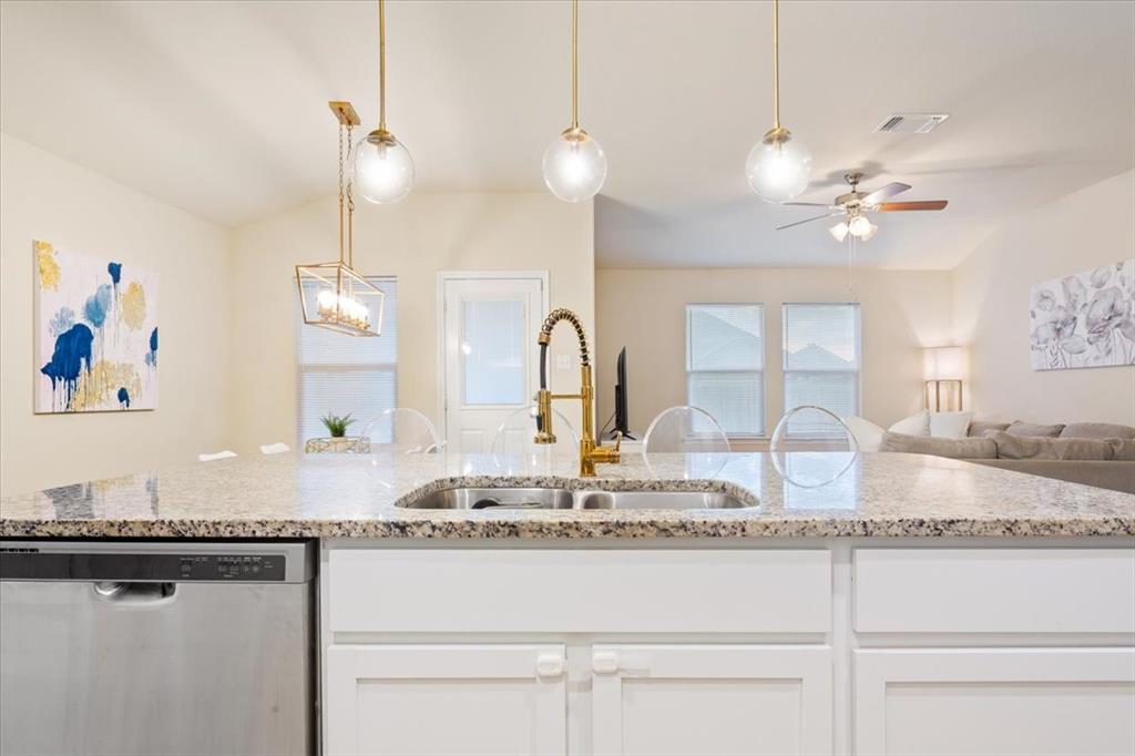 3105 Beutel Road Lorena, TX 76655 - Photo 13 of 26 a kitchen with kitchen island granite countertop a stove a sink and a granite counter top
