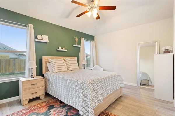 a bedroom with a bed and wooden floor