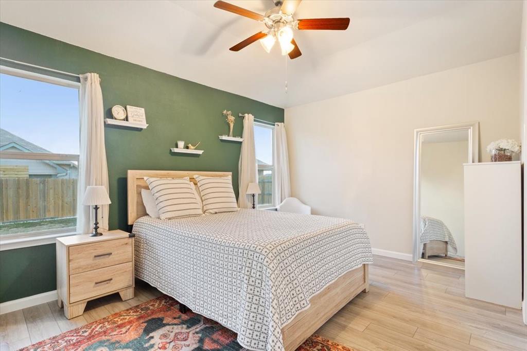 3105 Beutel Road Lorena, TX 76655 - Photo 14 of 26 a bedroom with a bed and wooden floor