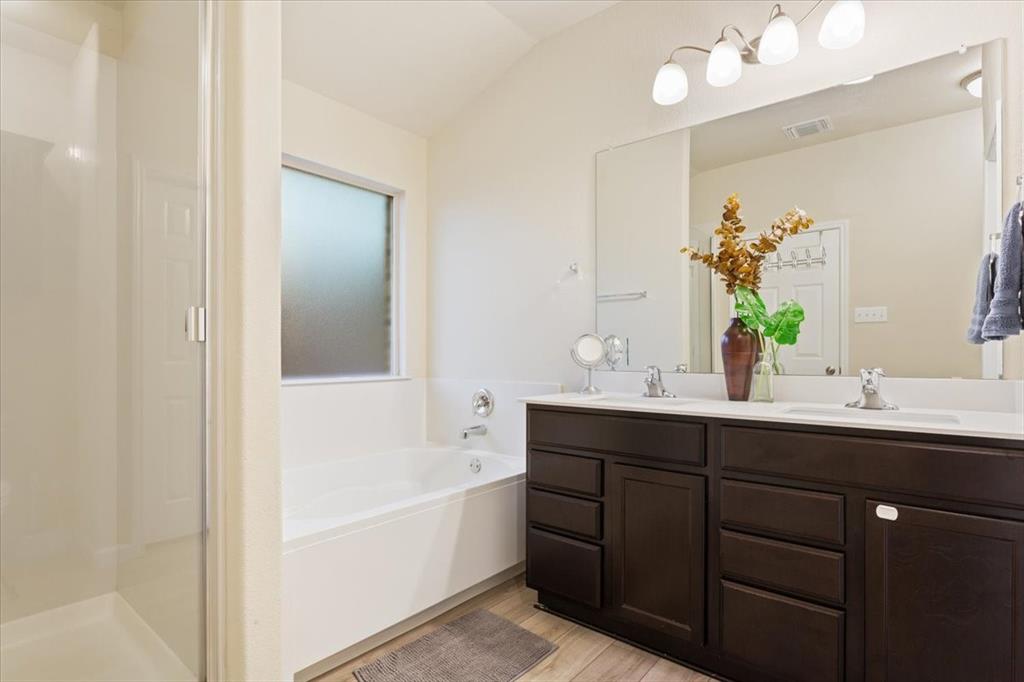 3105 Beutel Road Lorena, TX 76655 - Photo 16 of 26 a bathroom with a tub sink and mirror