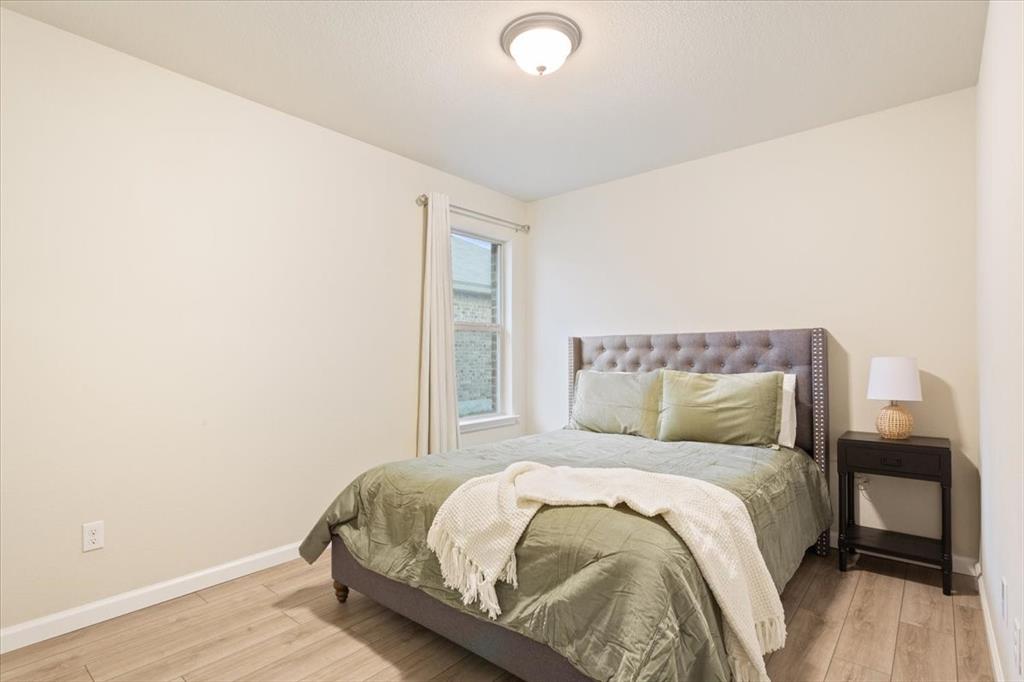 3105 Beutel Road Lorena, TX 76655 - Photo 18 of 26 a bed sitting in a bedroom next to a window