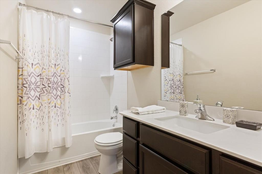 3105 Beutel Road Lorena, TX 76655 - Photo 19 of 26 a bathroom with a sink a toilet and shower