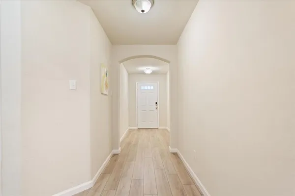 a view of a hallway with wooden floor