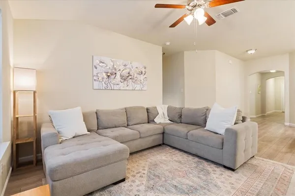 a living room with furniture and a large mirror
