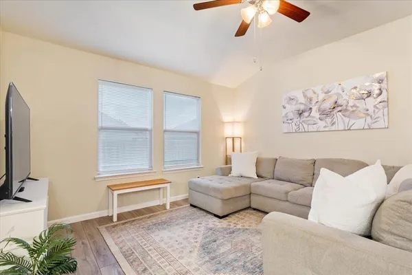 a living room with furniture and a flat screen tv