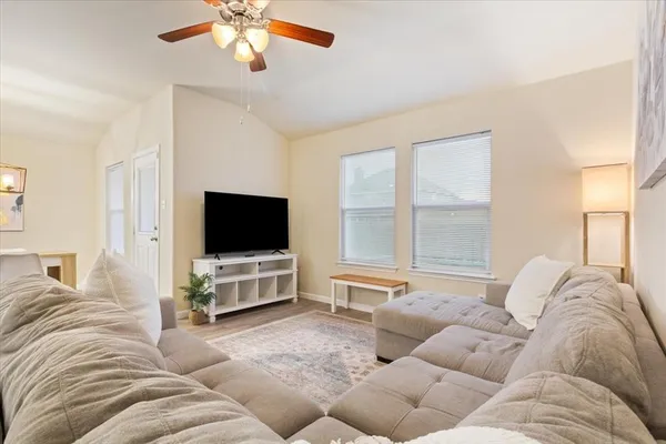 a living room with furniture and a flat screen tv