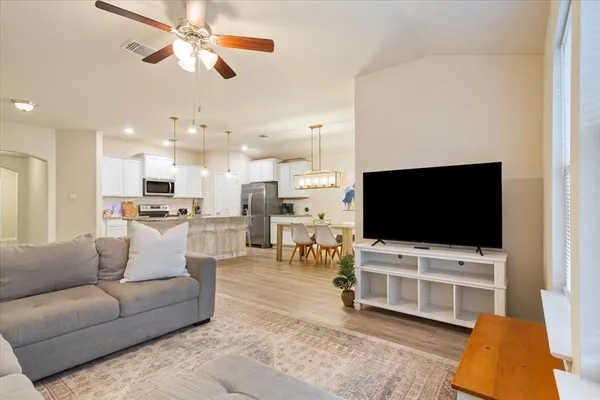 a living room with furniture and a flat screen tv