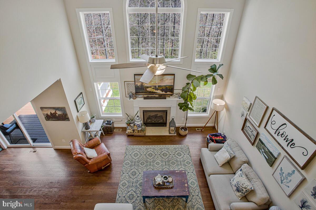 54 Simmons Ridge Road Prince Frederick, MD 20678 - Photo 38 of 55 a living room with furniture large window and a fireplace