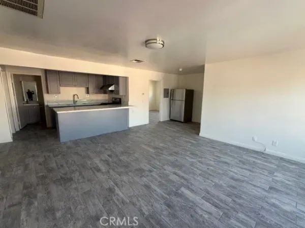a large white kitchen with a sink