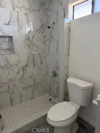 a white toilet sitting next to a bathroom sink