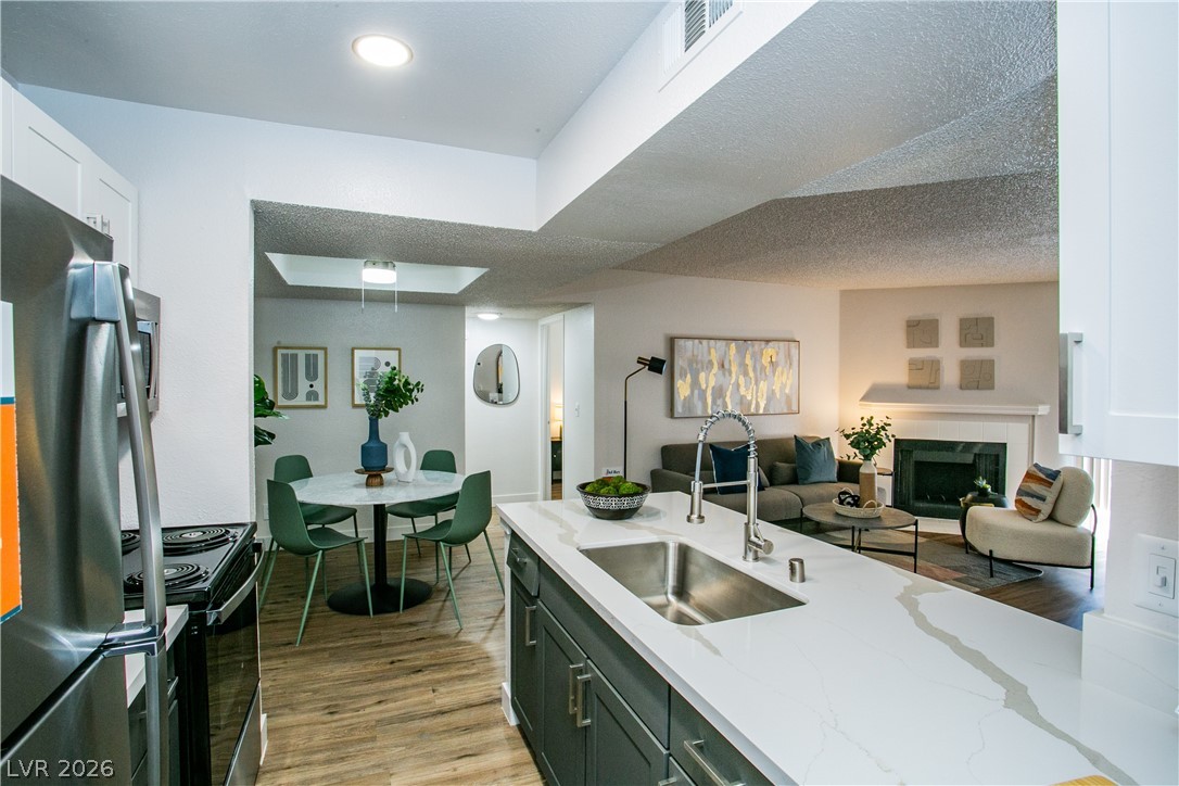 6750 Del Rey Avenue, Unit 108 Las Vegas, NV 89146 - Photo 1 of 11 This open concept living space features a modern kitchen, inviting dining area, and cozy living room.