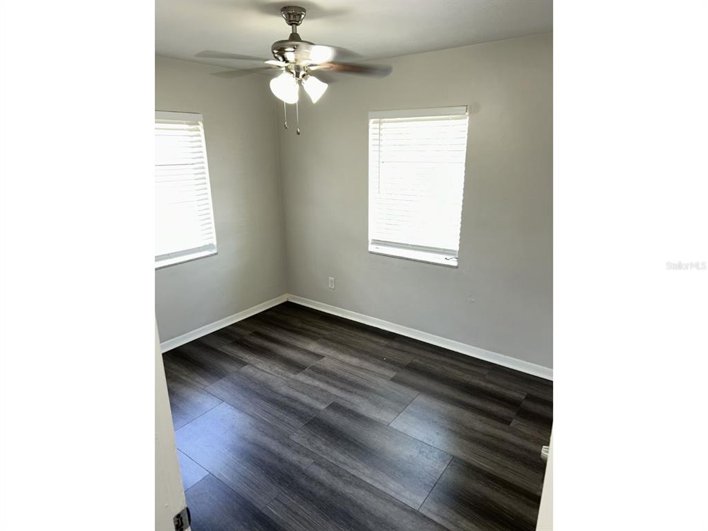 1241 Pilgrim Road Spring Hill, FL 34606 - Photo 20 of 28 a view of empty room with wooden floor