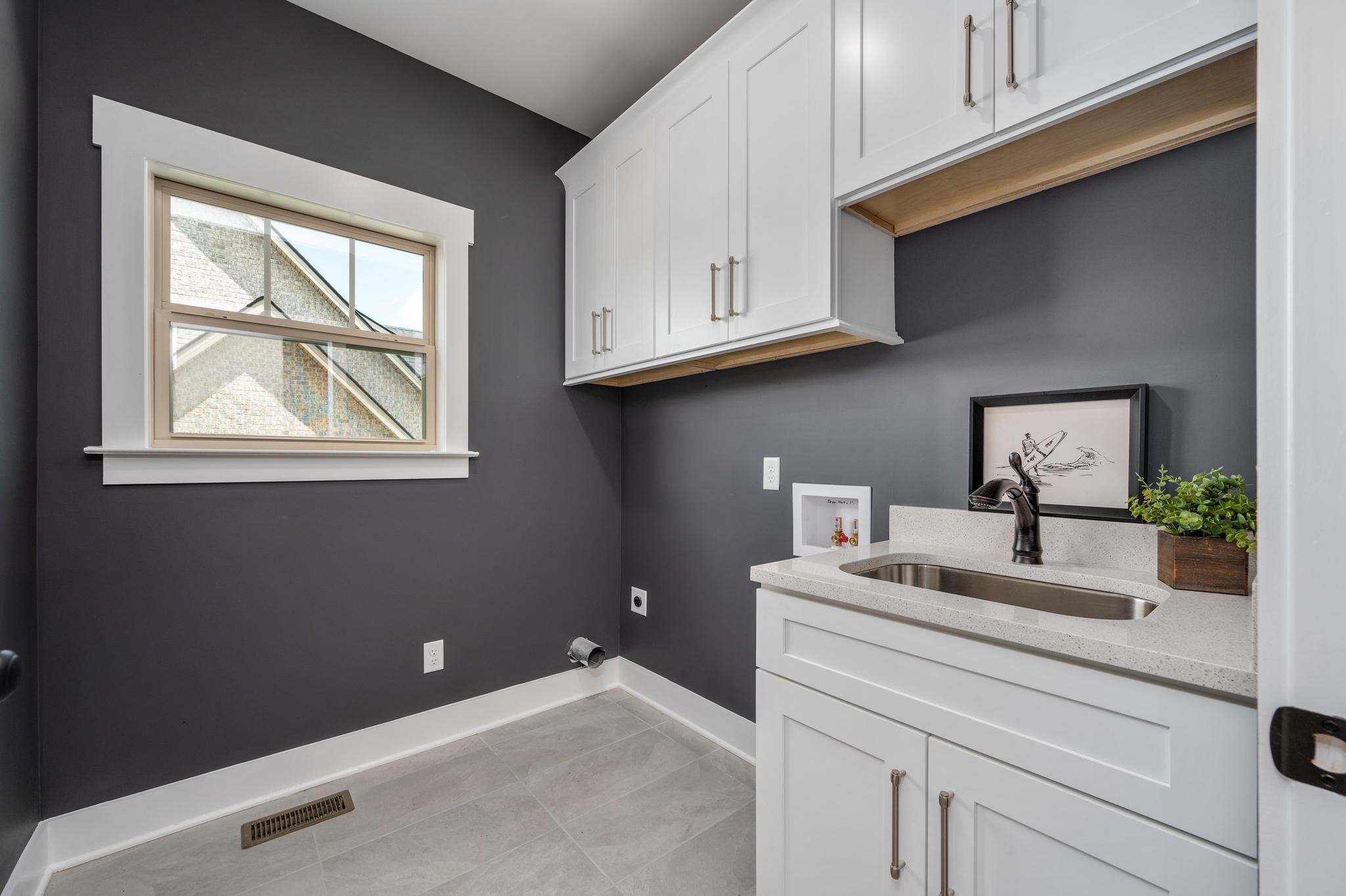 2416 Dilton Mankin Road Murfreesboro, TN 37127 - Photo 23 of 36 a room with kitchen island a stove a sink and a window