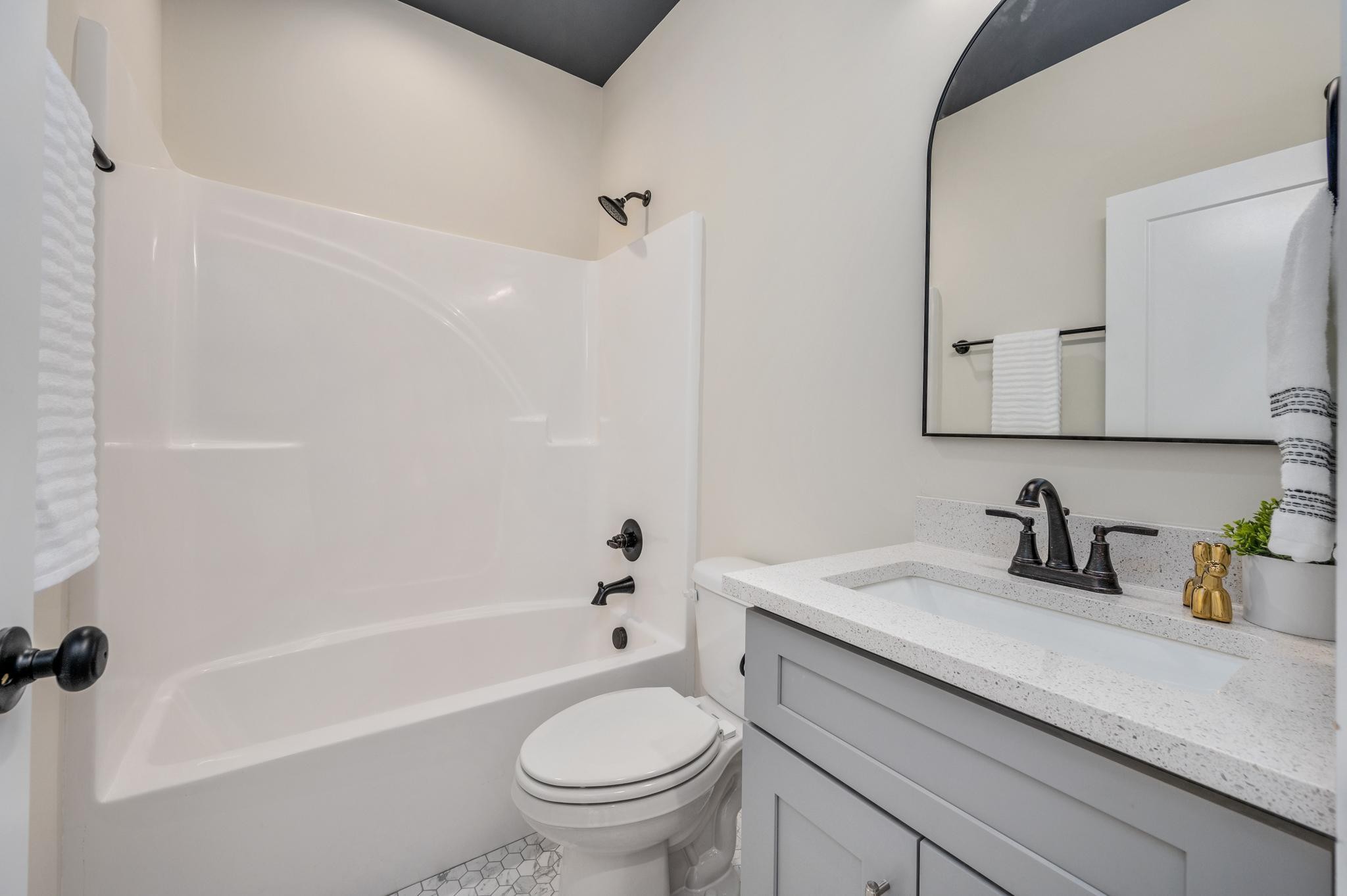 2416 Dilton Mankin Road Murfreesboro, TN 37127 - Photo 25 of 36 a bathroom with a sink a toilet and a bathtub