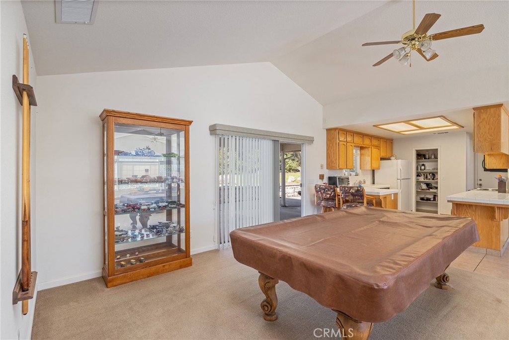 50174 Bissett Station Road Oakhurst, CA 93644 - Photo 16 of 75 a living room with a table chairs and a dining table