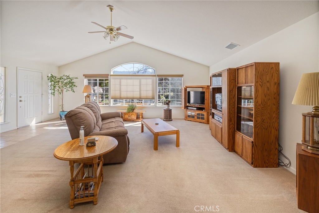 50174 Bissett Station Road Oakhurst, CA 93644 - Photo 18 of 75 a living room with furniture and a chandelier