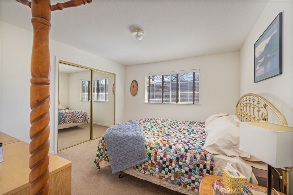 50174 Bissett Station Road Oakhurst, CA 93644 - Photo 28 of 75 a bedroom with a large bed and a window