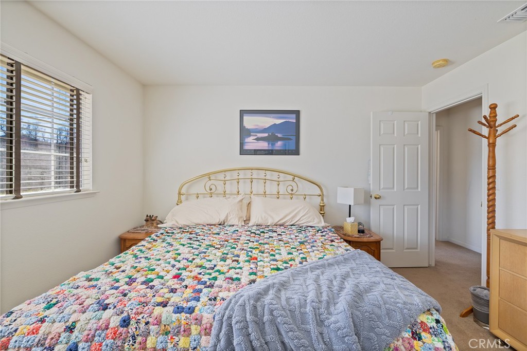 50174 Bissett Station Road Oakhurst, CA 93644 - Photo 30 of 75 a large bed sitting in a bedroom next to a window