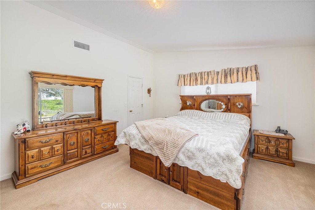 50174 Bissett Station Road Oakhurst, CA 93644 - Photo 4 of 75 a bedroom with a bed and dresser