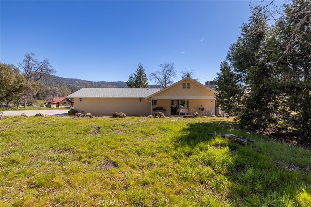 50174 Bissett Station Road Oakhurst, CA 93644 - Photo 47 of 75 a front view of a house with a yard