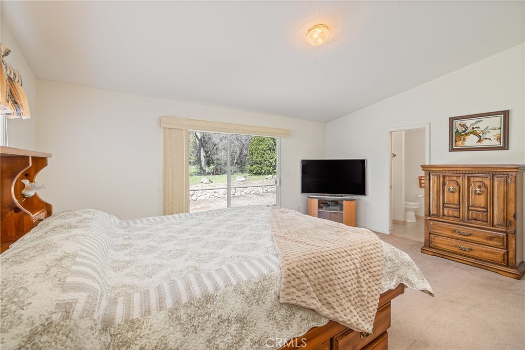 50174 Bissett Station Road Oakhurst, CA 93644 - Photo 5 of 75 a bedroom with a bed and a flat screen tv