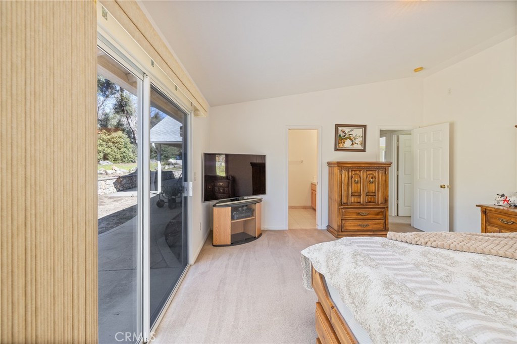 50174 Bissett Station Road Oakhurst, CA 93644 - Photo 6 of 75 a bedroom with furniture and a flat screen tv