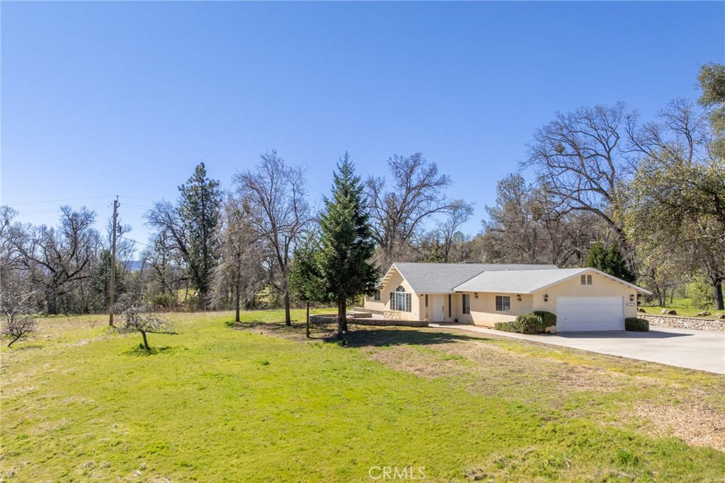 50174 Bissett Station Road Oakhurst, CA 93644 - Photo 64 of 75 a view of a swimming pool and trees in the background