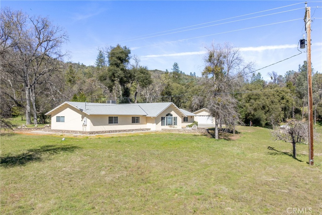 50174 Bissett Station Road Oakhurst, CA 93644 - Photo 66 of 75 a view of a house with a yard and sitting area