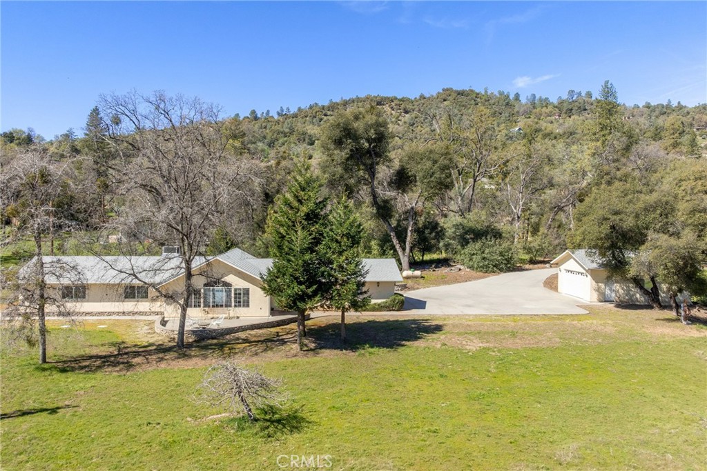 50174 Bissett Station Road Oakhurst, CA 93644 - Photo 68 of 75 a view of a lake with a mountain in the background