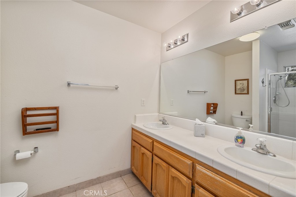 50174 Bissett Station Road Oakhurst, CA 93644 - Photo 7 of 75 a bathroom with a sink and a mirror
