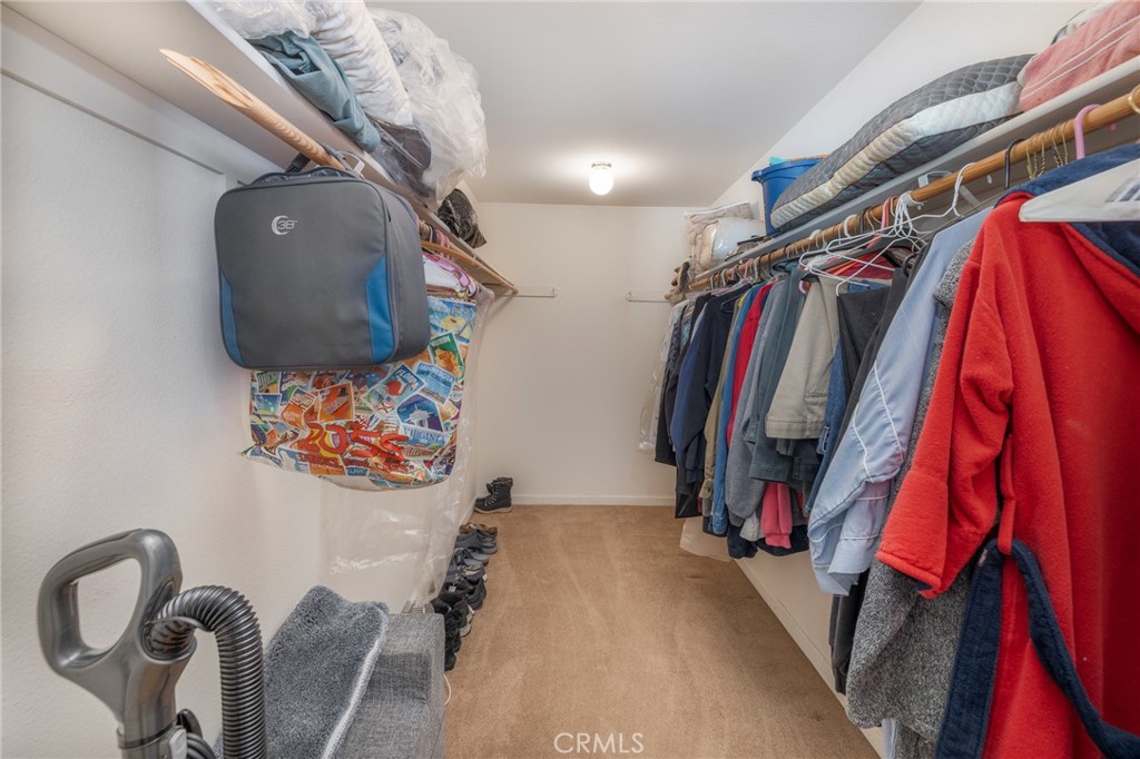 50174 Bissett Station Road Oakhurst, CA 93644 - Photo 9 of 75 a view of walk in closet with clothes and shoes