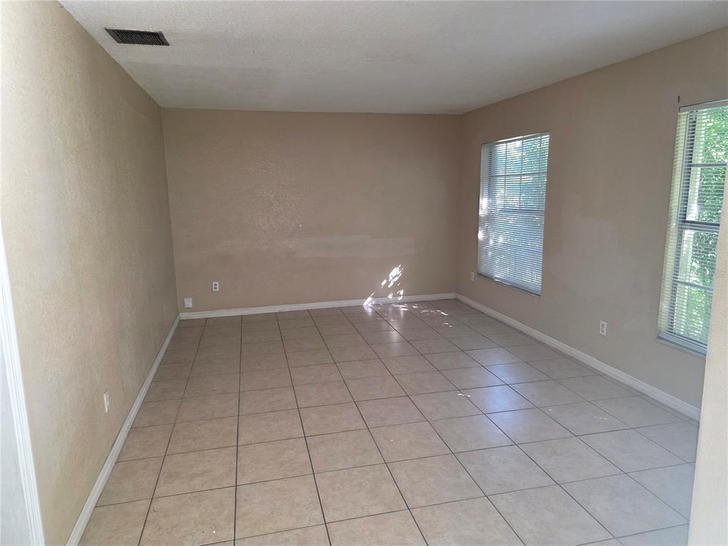 5905 Altec Road Orlando, FL 32808 - Photo 3 of 9 a view of an empty room with a window