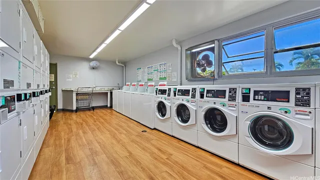 a view of a kitchen with wooden floor and electronic appliances