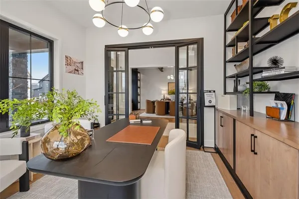 a room with stainless steel appliances furniture kitchen view and a chandelier