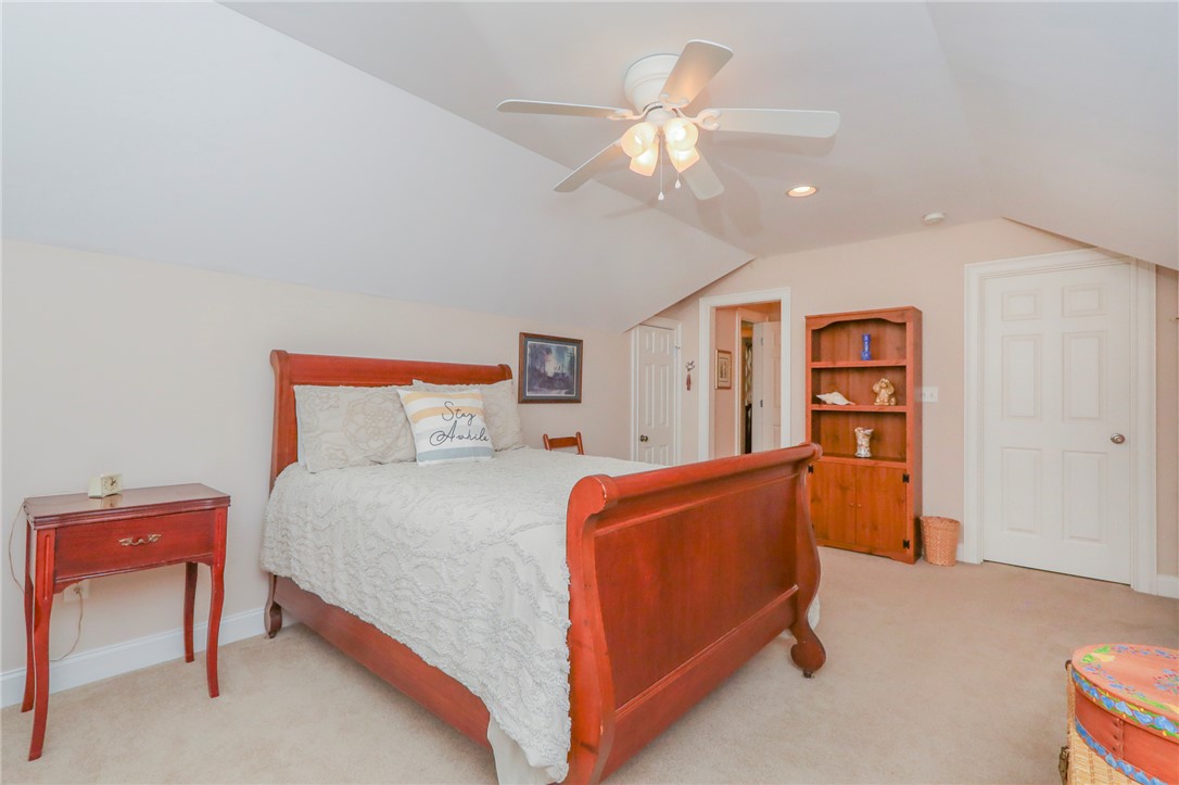 103 C-10-147D Anderson, SC 29621 - Photo 38 of 49 A comfortable bedroom features an angled ceiling and soft carpeting, perfect for restful living.