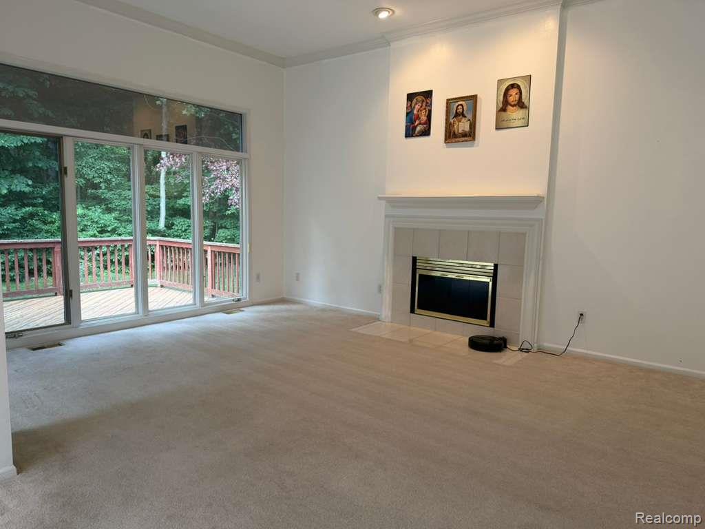 1154 Bluebird Drive Rochester, MI 48307 - Photo 8 of 34 Living area featuring a fireplace with a mantel, recessed lighting, and crown molding