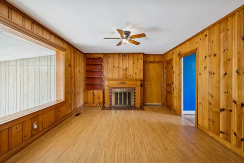 wooden floor in an empty room with a window