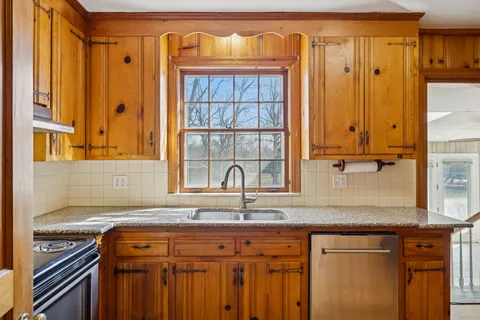 a kitchen with stainless steel appliances granite countertop a sink and a cabinets